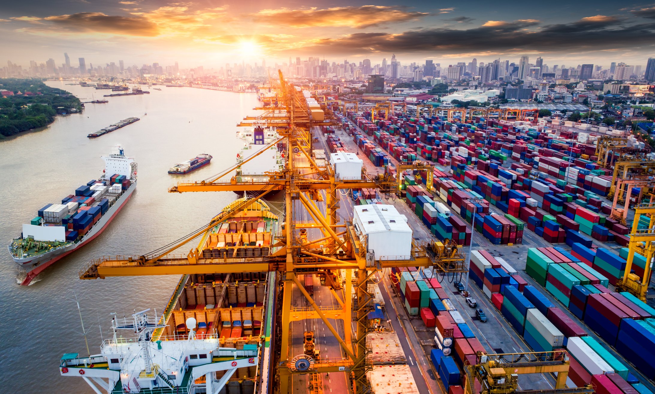 Logistics and transportation of Container Cargo ship and Cargo plane with working crane bridge in shipyard at sunrise